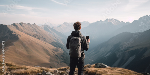hiker in the mountains taking a photo admiring beauty, background, copy space