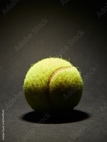 Tennis ball on black background © serdiukov