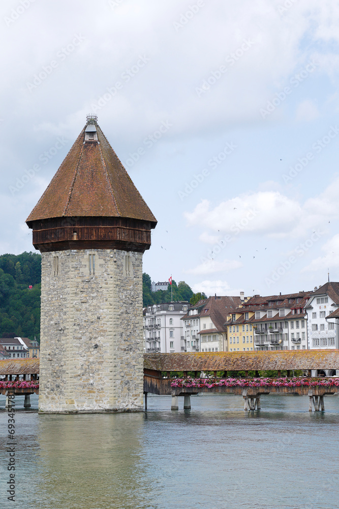 View of the Chapel Bridge and the Wasserturm (water tower) on river Reuss in historic city of Lucerne, Switzerland