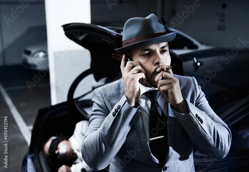 Smoking, car and man with hostage in trunk for negotiation, kidnapping ransom and phone call. Mafia, gangster criminal and business person in boot for abduction, danger and robbery in parking lot