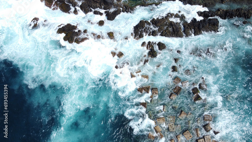 Aerial photo of strong and powerful ocean with huge waves. Rocks. photo