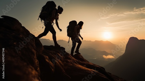 Silhouette People helping each other  hikers climbing up mountain cliff team work successfully © Joyous BG