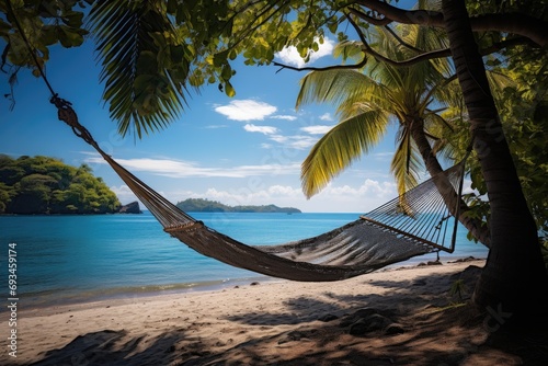 Peaceful beach scene with a hammock between palm trees, tropical relaxation