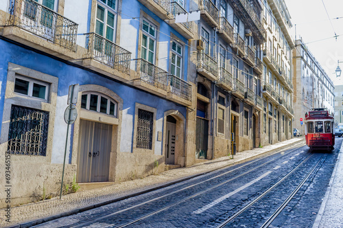 Street with a red old tram in the historic center of Lisbon, Portugal, Europe