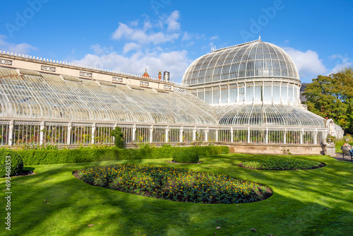 Exterior view of Palm House, a cast iron glasshouse designed in the 19th century by Charles Lanyon, in the Botanic Gardens near Ulster Museum, Belfast, Northern Ireland.