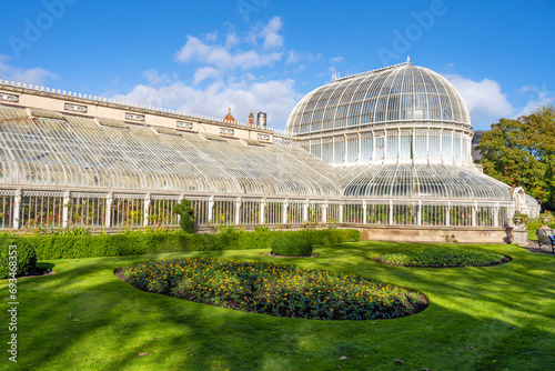 Exterior view of Palm House, a cast iron glasshouse designed in the 19th century by Charles Lanyon, in the Botanic Gardens near Ulster Museum, Belfast, Northern Ireland.