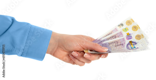 Female hand holding British pounds currency isolated on white background