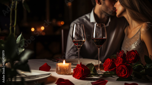 A well dressed couple having romantic dinner date at luxury restaurant, red roses and wine on the table with unrecognizable person, celebrating Valentine s day concept. photo