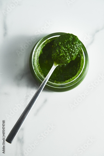 Pesto genovese or Pesto Verde. Italian sauce dip for pasta or other dishes. Green Pesto with basil and pine nuts and parmesan cheese.