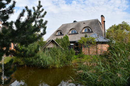 Traditional Lithuanian manor with garden pond.