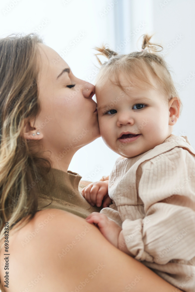 young beautiful mother with a baby girl having great time at home young beautiful mother with a baby girl having great time at home