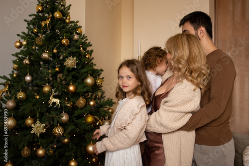 happy family enjoying their time together at home. Christmas tree on background