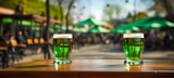 StPatrick s day celebration  glass of green beer on blurred background with copy space