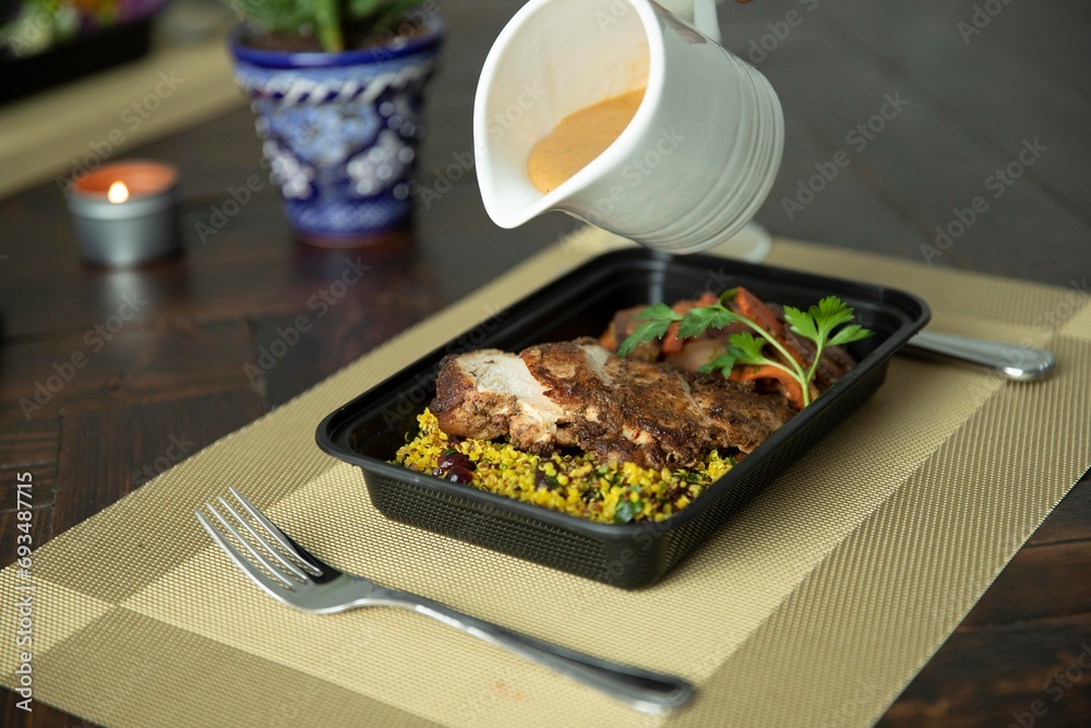 Pouring gravy on protein