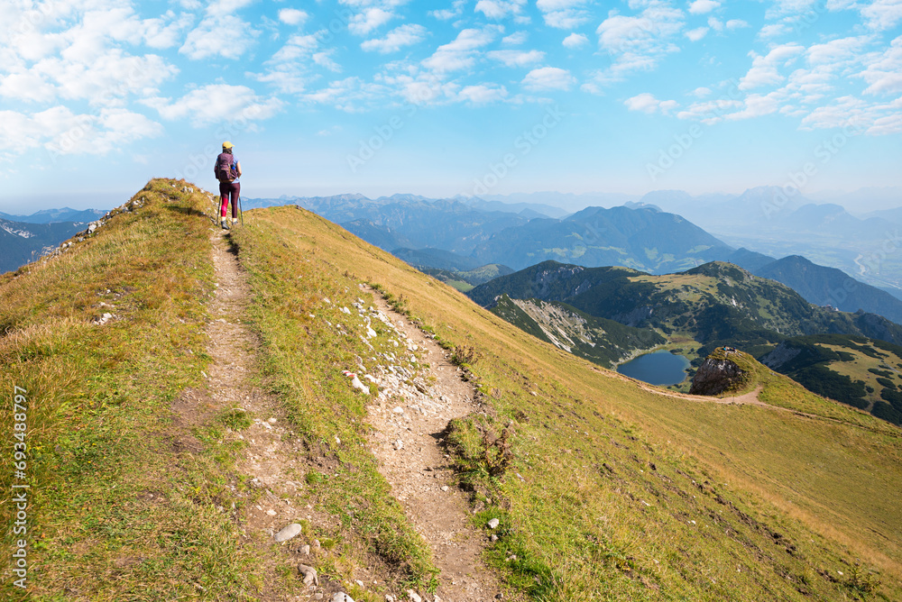 young woman at hiking trail Rofanspitze, looking to lake  Zireiner See and Inntal valley