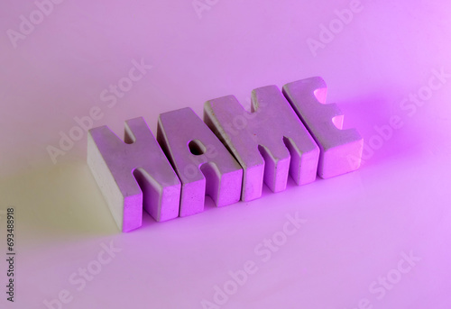 NAME written in concrete letters under illuminated vibrant colos photo