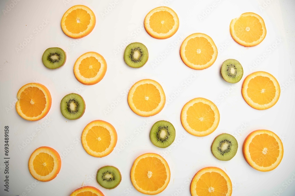 Kiwi and orange slices on a white background Kiwi and orange slices on a white background