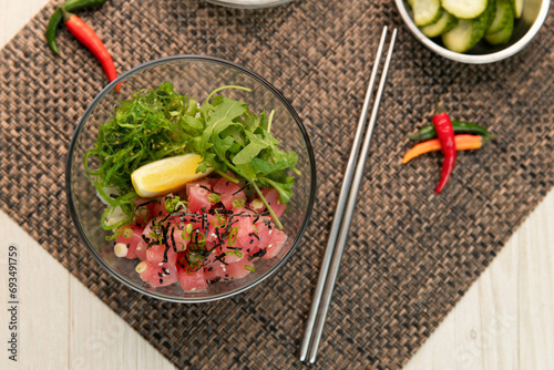Tuna, poke bowl with fresh vegetables and white rice.
