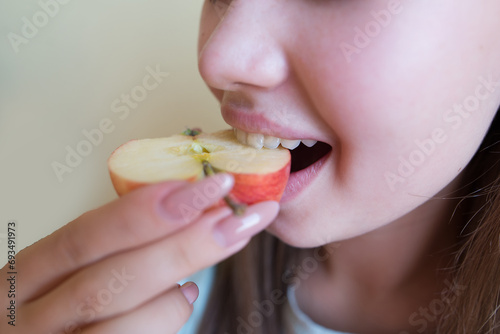 beautiful woman eating a red apple, close-up.