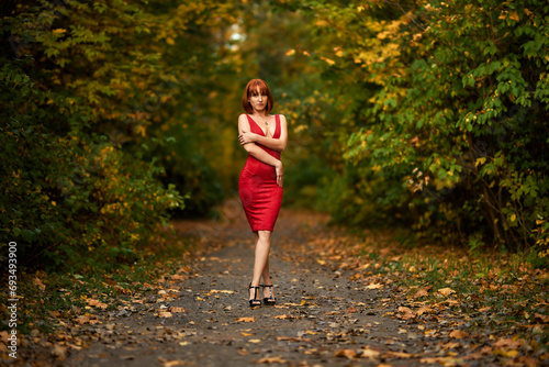 Fototapeta Naklejka Na Ścianę i Meble -  Sensual Redhead Outdoors: Autumn's Warm Embrace