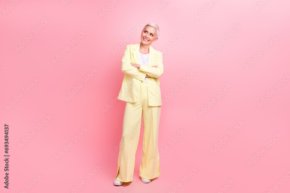 Real estate realtor photo of senior business lady folded hands in yellow suit look empty space good deal isolated on pink color background Real estate realtor photo of senior business lady folded hands in yellow suit look empty space good deal isolated on pink color background