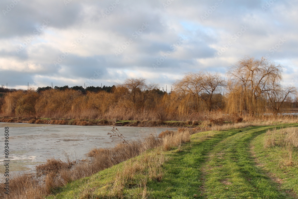 A river with grass and trees around it A river with grass and trees around it