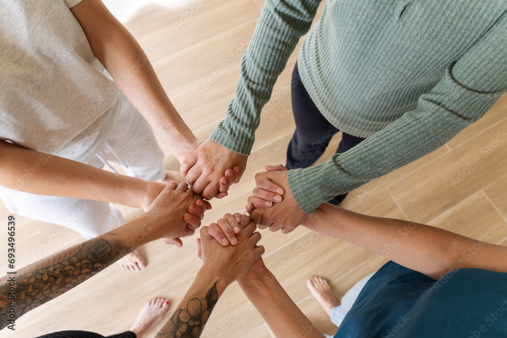 Obraz premium overhead shot of clasped hands. friendship and respect concept
