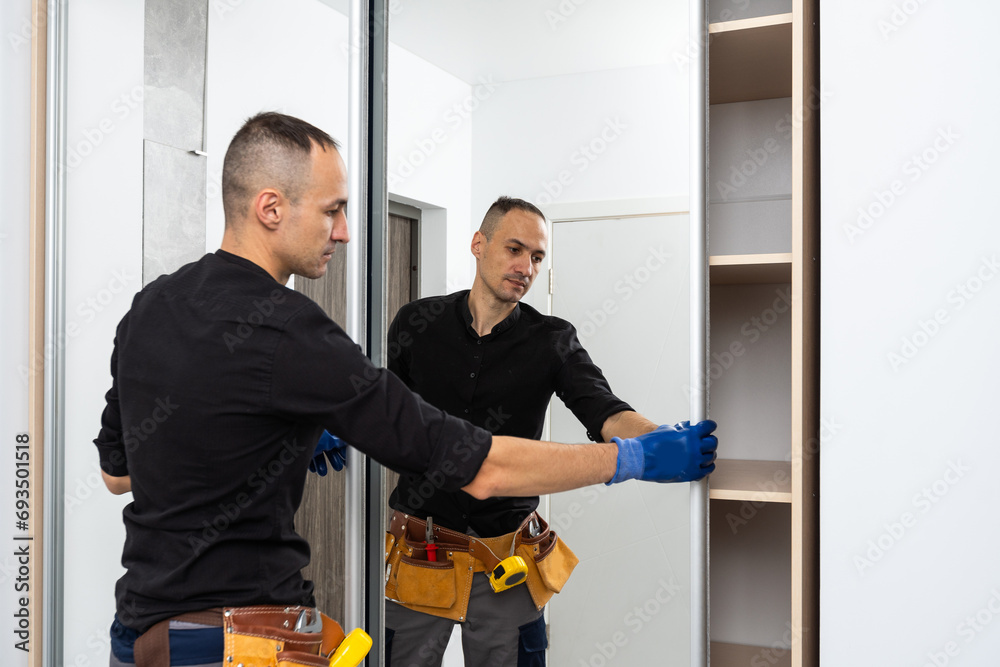 The man is engaged in repair and furniture assemblage The man is engaged in repair and furniture assemblage