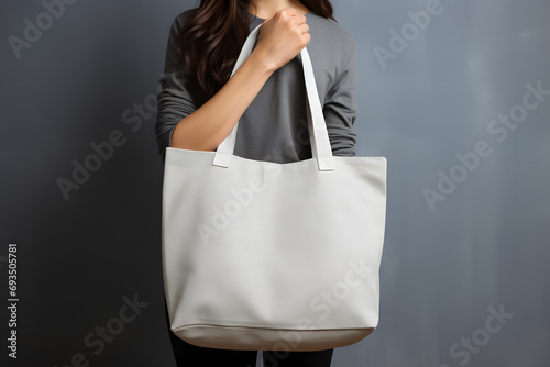 Mock up of pure white tote bag on grey background