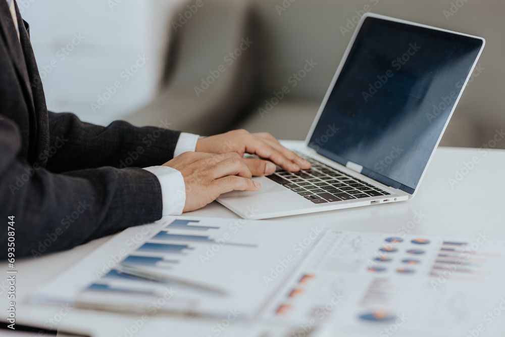 Businessman's hands with laptop computer, data document, company budget Marketing analysis Business accounting concept. Businessman - obrazy, fototapety, plakaty 
