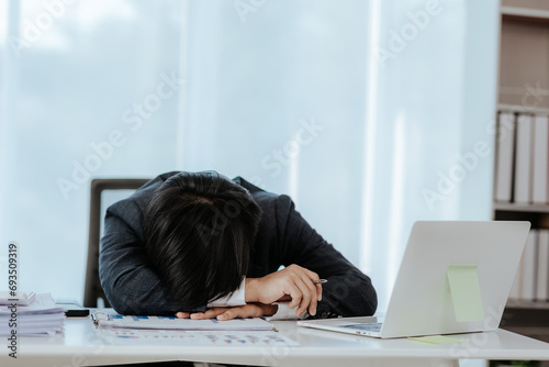 burnout disease Asian male businessman feels uncomfortable at work which is caused by accumulated stress from unsuccessful work and the body gets little rest Consult an expert psychiatrist.