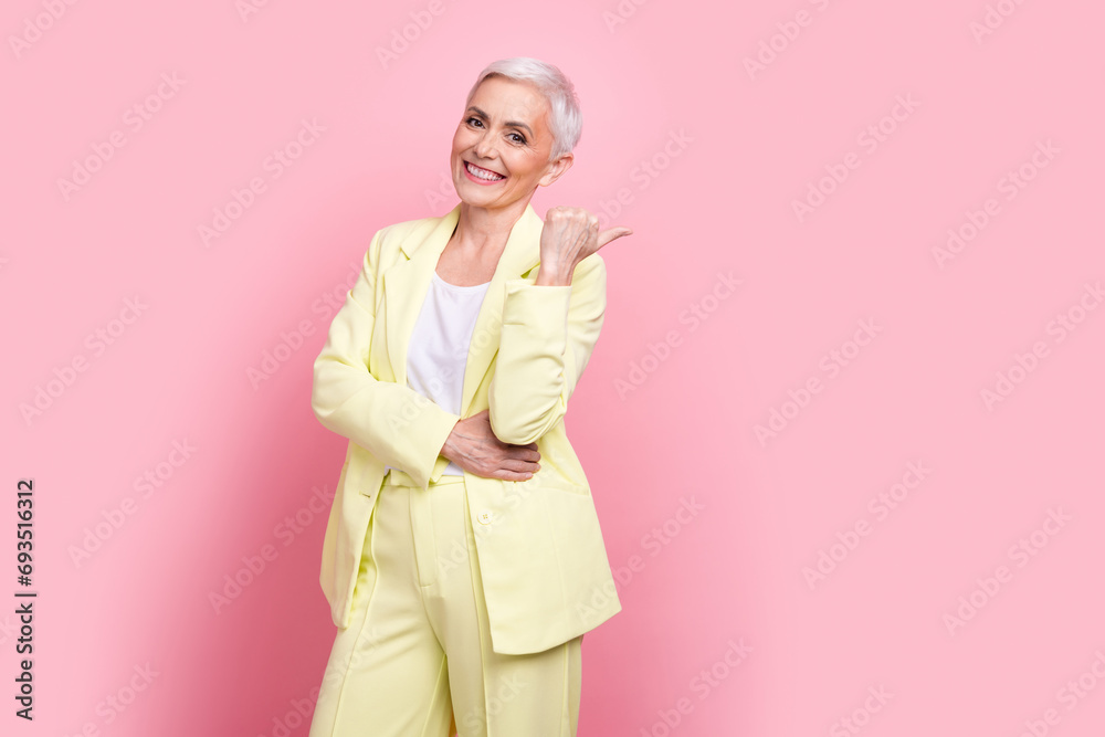 Photo of beautiful businesswoman dressed classy yellow suit point finger banner formal clothes boutique isolated on pink color background Photo of beautiful businesswoman dressed classy yellow suit point finger banner formal clothes boutique isolated on pink color background