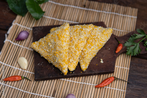 risoles filled with chicken, indonesian food, coating with bread crumb, decorated with condiment and garnish, unfried food. photo