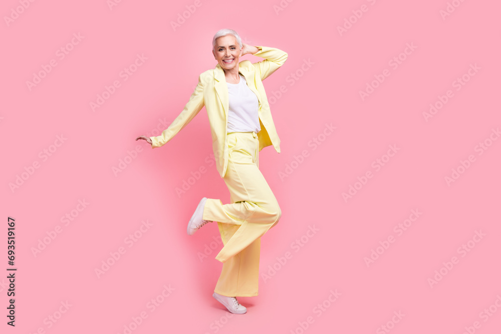 Full body photo of funky optimistic nice person dressed yellow jacket trousers dancing having fun isolated on pink color background