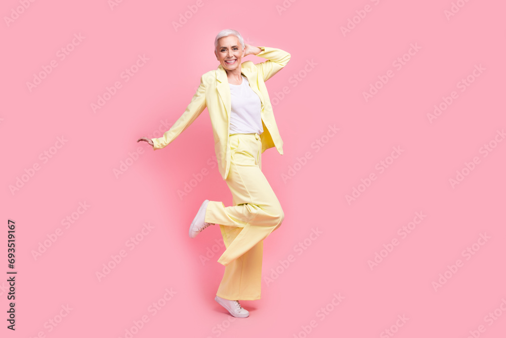 Full body photo of funky optimistic nice person dressed yellow jacket trousers dancing having fun isolated on pink color background Full body photo of funky optimistic nice person dressed yellow jacket trousers dancing having fun isolated on pink color background