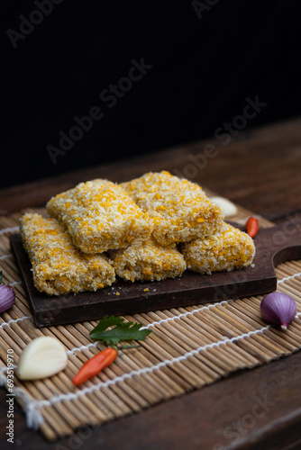 risoles filled with chicken, indonesian food, coating with bread crumb, decorated with condiment and garnish, unfried food. photo