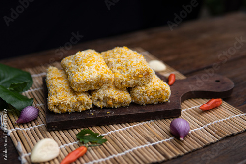 risoles filled with chicken, indonesian food, coating with bread crumb, decorated with condiment and garnish, unfried food. photo