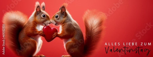 Alles Liebe zum Valentinstag, Grußkarte mit deutschem Text - Niedliches Eichhörnchen Päärchen hält rotes Herz , isoliert auf rotem Hintergrund © Corri Seizinger