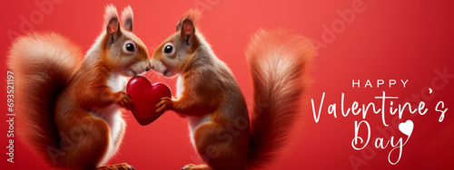 Happy Valentine's Day, Valentines Day, love, celebration concept greeting card - Cute red squirrel couple holding a red heart , isolated on red background © Corri Seizinger