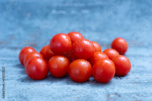 Red cherry tomatoes sprinkled with drops of water