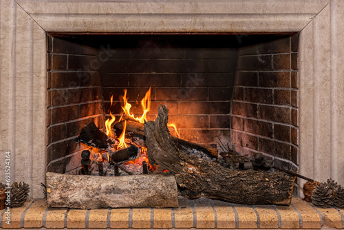 Glowing fire in a huge stone fireplace.