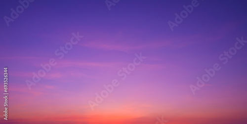 Colorful romantic twilight sky with beautiful pink sunset cloud and orange sunlight on dark blue sky after sundown in evening time, idyllic peaceful nature panoramic background photo