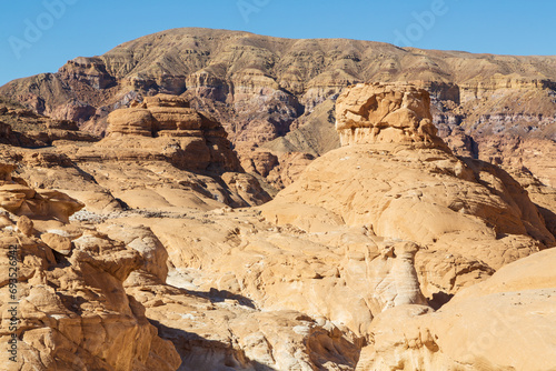 Sinai desert. Yellow and orange sandstone textured carved mountain  bright blue sky. Egyptian desert landscape. Sinai peninsula  Egypt