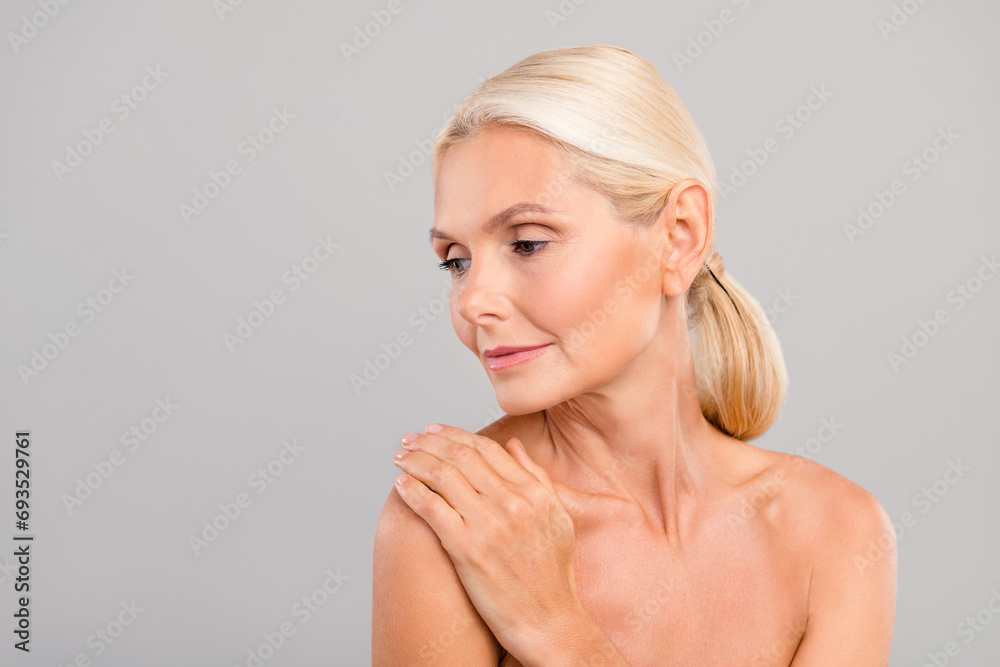 Portrait of dreamy charming lovely woman hand touching naked shoulders after shower gel peeling isolated on gray color background