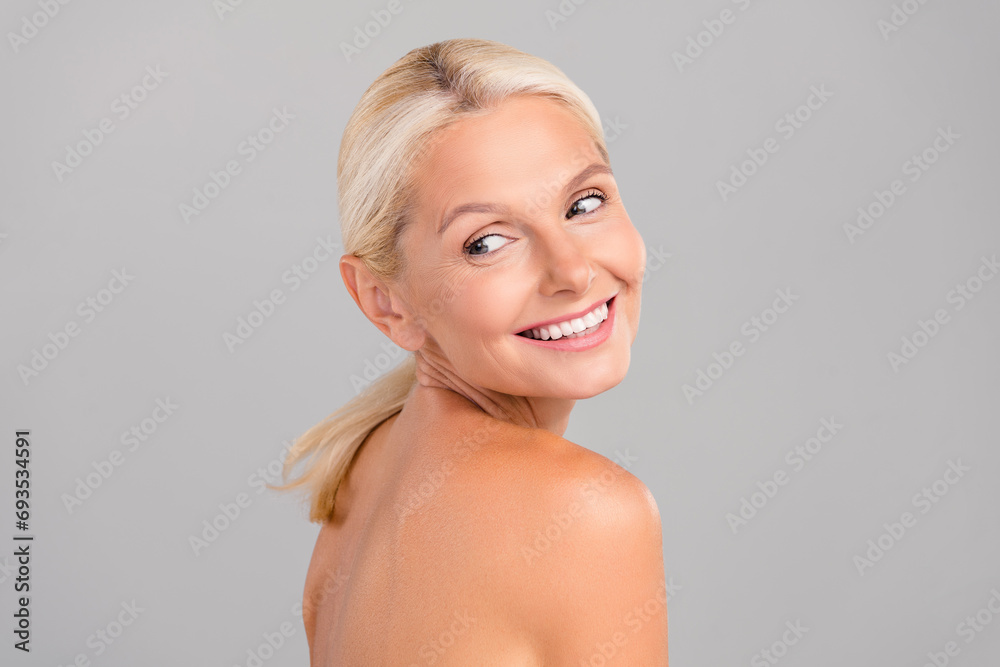 Portrait of happy pensioner lady look empty space advertise beauty skin care product isolated grey color background Portrait of happy pensioner lady look empty space advertise beauty skin care product isolated grey color background