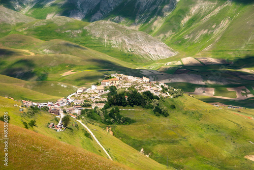 Picturesque mountain town in Italy among meadows