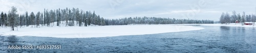 Winter in Finland: landscape in ultra panorama format with river in snow covered boreal forest © Chris