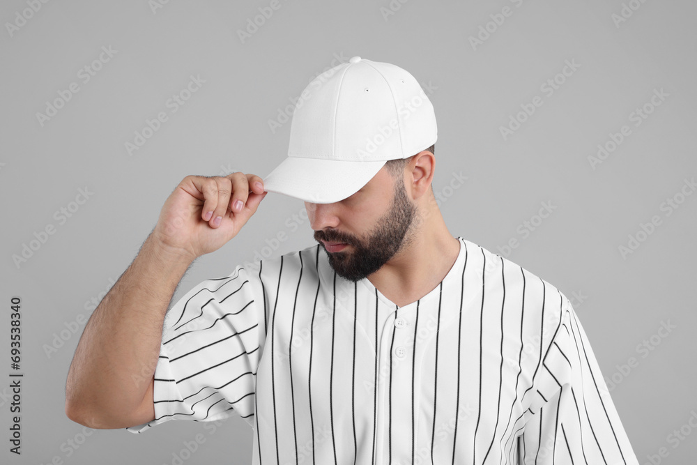Man in stylish white baseball cap on light grey background