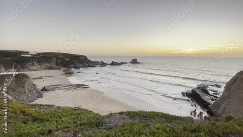 Sunset and calm waves at Zambujeira do Mar beach in Portugal. Organic and natural textures in nature photo