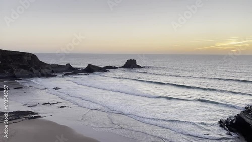 Sunset and calm waves at Zambujeira do Mar beach in Portugal. Organic and natural textures in nature photo